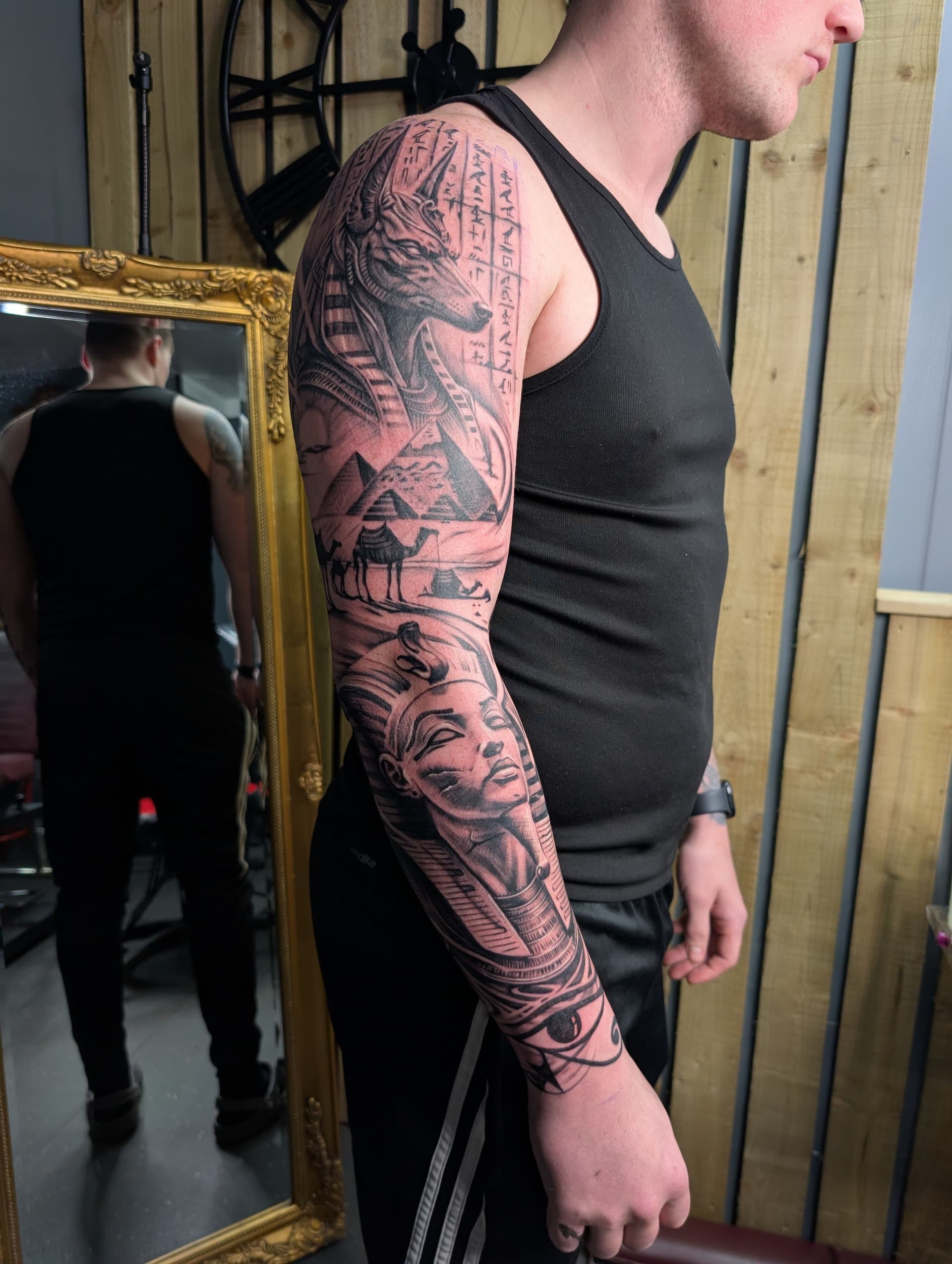 Detailed black and grey realism Egyptian themed tattoo sleeve on arm.