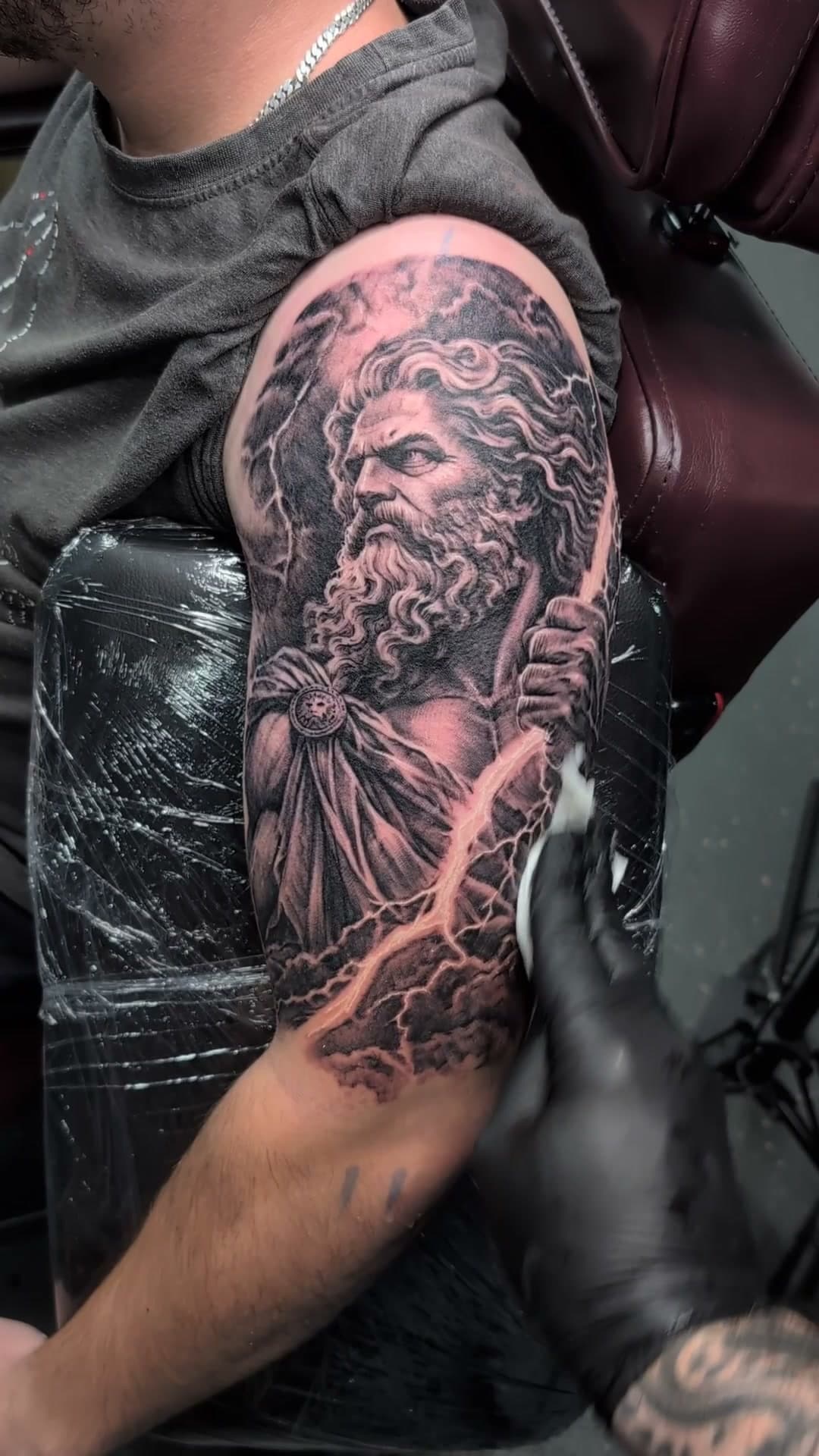 Zeus with lightning bolt upper arm tattoo, stencil to reveal
